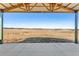 View from inside the barn looking out at the countryside with fencing and a beautiful blue sky at 5537 Lake Gulch Rd, Castle Rock, CO 80104
