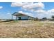 Exterior view of barn featuring tan and green exterior, and fenced pasture area on a beautiful day at 5537 Lake Gulch Rd, Castle Rock, CO 80104