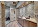 Spa-like bathroom with wood and stone finishes, a double vanity, and a contemporary walk-in shower at 5537 Lake Gulch Rd, Castle Rock, CO 80104