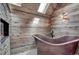 Tranquil bathroom with a copper soaking tub, wood accents, and a built-in fireplace for ultimate relaxation at 5537 Lake Gulch Rd, Castle Rock, CO 80104