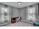 Bright bedroom with dual windows, a functional desk, and chair setup, providing a well-lit workspace at 5537 Lake Gulch Rd, Castle Rock, CO 80104