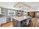 Spacious kitchen with granite island, stainless steel appliances and hood at 5537 Lake Gulch Rd, Castle Rock, CO 80104