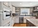 Bright kitchen featuring white cabinets, stainless steel appliances, and granite counters at 5537 Lake Gulch Rd, Castle Rock, CO 80104
