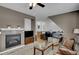 Cozy living room featuring a fireplace with tiled surround, wood floors, and comfortable furnishings at 5537 Lake Gulch Rd, Castle Rock, CO 80104