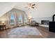 Bright and airy living room with a fireplace, comfortable seating, and large windows showcasing scenic views at 5537 Lake Gulch Rd, Castle Rock, CO 80104