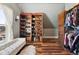 Organized walk-in closet featuring custom shelving, ample storage, and a stylish seating area at 5537 Lake Gulch Rd, Castle Rock, CO 80104