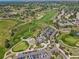 Aerial view of a golf course, clubhouse, and surrounding neighborhood at 6503 S Quemoy Way, Aurora, CO 80016