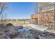 Beautiful backyard with a serene pond and deck at 6503 S Quemoy Way, Aurora, CO 80016