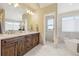 Well-appointed bathroom features double vanity and separate soaking tub and shower at 6503 S Quemoy Way, Aurora, CO 80016