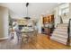 Dining room view showcasing a glass table, bar, and staircase with wrought iron at 6503 S Quemoy Way, Aurora, CO 80016