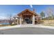 Exterior of a building with stone pillars, wood beams, and a covered entrance at 6503 S Quemoy Way, Aurora, CO 80016