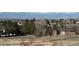 A charming home is surrounded by lush greenery and a picturesque landscape with mountain views in the background at 6503 S Quemoy Way, Aurora, CO 80016