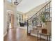 Inviting foyer with hardwood floors, a grand staircase, and a view into the home's living spaces at 6503 S Quemoy Way, Aurora, CO 80016