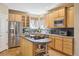 Bright kitchen features an island cooktop, modern appliances, and sunlit windows at 6503 S Quemoy Way, Aurora, CO 80016