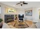 Inviting living room featuring fireplace, built-in shelves, and decorative art at 6503 S Quemoy Way, Aurora, CO 80016