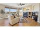 Sun-filled living room with floor to ceiling windows, fireplace, and hardwood floors at 6503 S Quemoy Way, Aurora, CO 80016