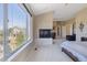 Bright main bedroom boasts views, fireplace, seating area, and neutral decor at 6503 S Quemoy Way, Aurora, CO 80016