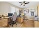 Comfortable office with wood floors, granite countertops, and dual computer setups at 6503 S Quemoy Way, Aurora, CO 80016