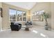 Sunlit sitting area with large windows, comfortable seating, and a tranquil atmosphere at 6503 S Quemoy Way, Aurora, CO 80016