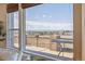Panoramic view through large windows showcasing a deck and scenic landscape at 6503 S Quemoy Way, Aurora, CO 80016