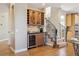 Cozy wet bar featuring wine fridge, wood cabinetry, and stone backsplash detail at 6503 S Quemoy Way, Aurora, CO 80016