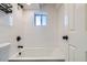Stylish bathroom with a sleek bathtub, a shower, and a window for natural light at 1180 Yosemite St # 110, Denver, CO 80220