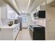 Clean kitchen with white cabinets, modern appliances, and herringbone tile backsplash at 1180 Yosemite St # 110, Denver, CO 80220