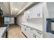 Modern kitchen featuring white cabinets, stainless steel appliances, and ample counter space at 1180 Yosemite St # 110, Denver, CO 80220