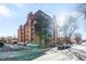 Brick building exterior with parking and street view at 1008 N Corona St # 204, Denver, CO 80218