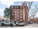 Brick apartment building with landscaping and ample parking at 1008 N Corona St # 204, Denver, CO 80218