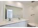 Clean bathroom featuring double sinks with white countertops, and a shower/tub with white tile at 15285 Milwaukee St, Thornton, CO 80602