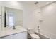 Bright bathroom featuring single sink with white countertops, and a shower/tub with white tile at 15285 Milwaukee St, Thornton, CO 80602