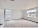 Large, bright bedroom with neutral carpet and two windows that allow for lots of natural light at 15285 Milwaukee St, Thornton, CO 80602
