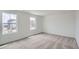 Bright bedroom features neutral carpet, two windows, and a minimalist design at 15285 Milwaukee St, Thornton, CO 80602