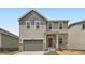 Charming two-story home featuring a stone-accented entry, attached garage, and neutral siding in a well-maintained neighborhood at 15285 Milwaukee St, Thornton, CO 80602