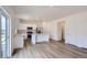 Open-concept kitchen with stainless steel appliances, white cabinets, island, and access to the outside from large sliding glass doors at 15285 Milwaukee St, Thornton, CO 80602