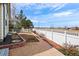 Backyard with white fence, mulch, and rock landscaping at 1128 S Duquesne Cir, Aurora, CO 80018