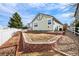 Backyard with a white fence and brick edging, plus an area prepared for planting at 1128 S Duquesne Cir, Aurora, CO 80018