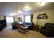 Basement featuring carpet, dark leather furniture, and windows at 1128 S Duquesne Cir, Aurora, CO 80018