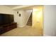 Carpeted basement featuring entertainment center and stairway at 1128 S Duquesne Cir, Aurora, CO 80018