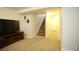 Finished basement area with carpeting, media console, and stairs at 1128 S Duquesne Cir, Aurora, CO 80018