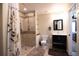 Stylish bathroom featuring a tiled shower, modern vanity, decorative mirror, and neutral tones at 1128 S Duquesne Cir, Aurora, CO 80018