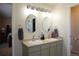 Bathroom featuring double sinks, large mirrors, and vanity lighting at 1128 S Duquesne Cir, Aurora, CO 80018