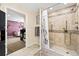 Tiled bathroom with a walk-in shower, neutral color scheme, and modern fixtures at 1128 S Duquesne Cir, Aurora, CO 80018