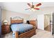 Bedroom featuring carpet, ceiling fan, and wooden furniture at 1128 S Duquesne Cir, Aurora, CO 80018