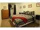 Inviting bedroom features a comfortable bed, dresser, and closet, offering a tranquil retreat at 1128 S Duquesne Cir, Aurora, CO 80018