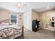 Bedroom featuring neutral colored walls, carpet flooring, natural lighting, and a view to the ensuite bathroom at 1128 S Duquesne Cir, Aurora, CO 80018