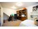 Well-lit bedroom showcases a built-in desk, shelving, and comfortable space for work or relaxation at 1128 S Duquesne Cir, Aurora, CO 80018