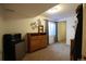 Bedroom with a window, dresser, mini-refrigerator, and neutral carpet at 1128 S Duquesne Cir, Aurora, CO 80018