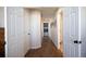 Hallway with hardwood floors connecting living areas to laundry room at 1128 S Duquesne Cir, Aurora, CO 80018
